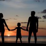 silhouette of a family holding hands during sunset